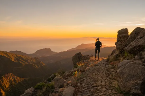 a man standing on a rocky hill