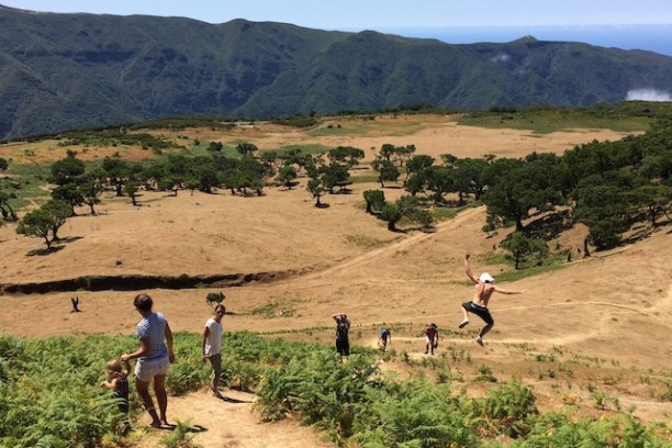 a group of people walking down a dirt road