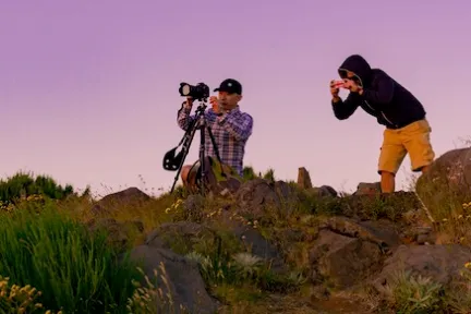 a man standing on a rocky hill
