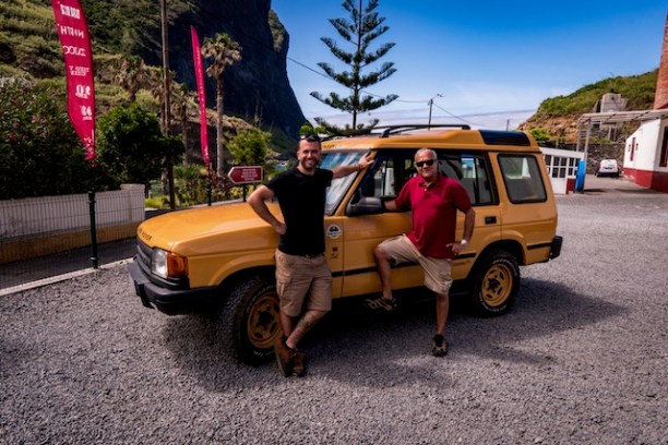 a person standing in front of a car