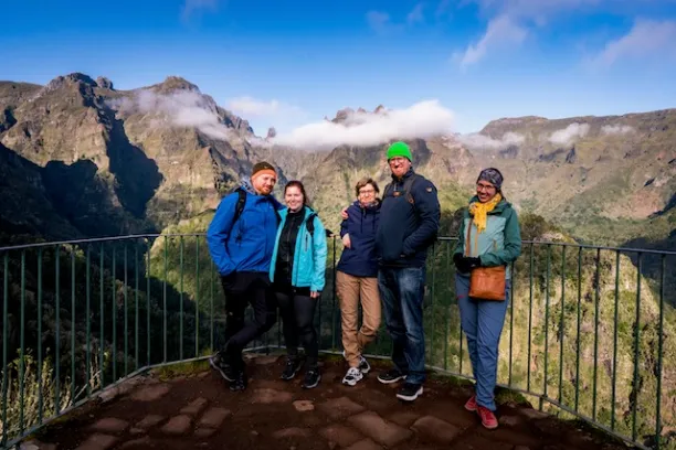 a group of people standing on top of a mountain