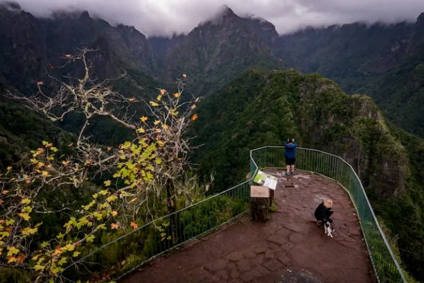 a person standing in front of a mountain