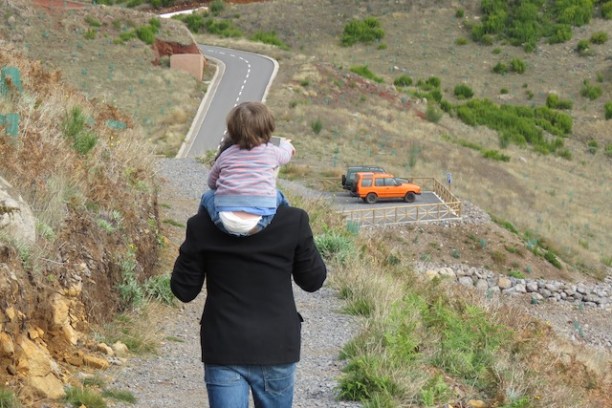 a little boy that is standing in the grass