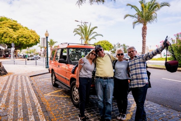 a group of people walking down a street next to a bus