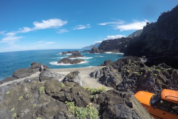 a rocky beach next to a body of water