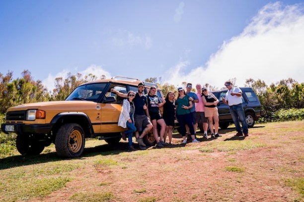 a group of people standing in front of a truck
