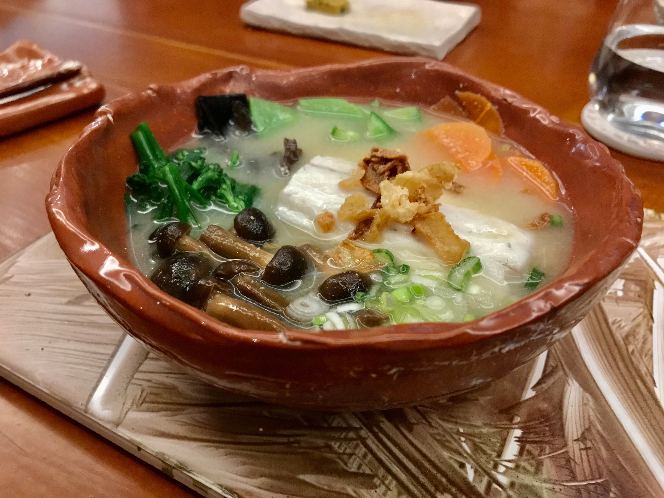 a plate of food sitting on top of a wooden table