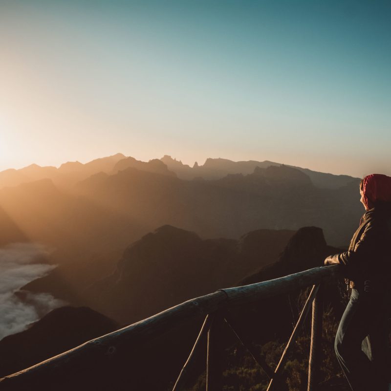 a person standing in front of a sunset