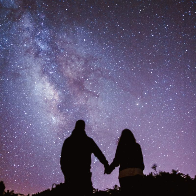 a group of people in a dark sky