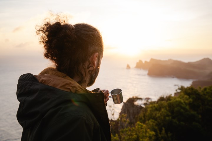 Guest enjoying sunrise over a Madeira bay